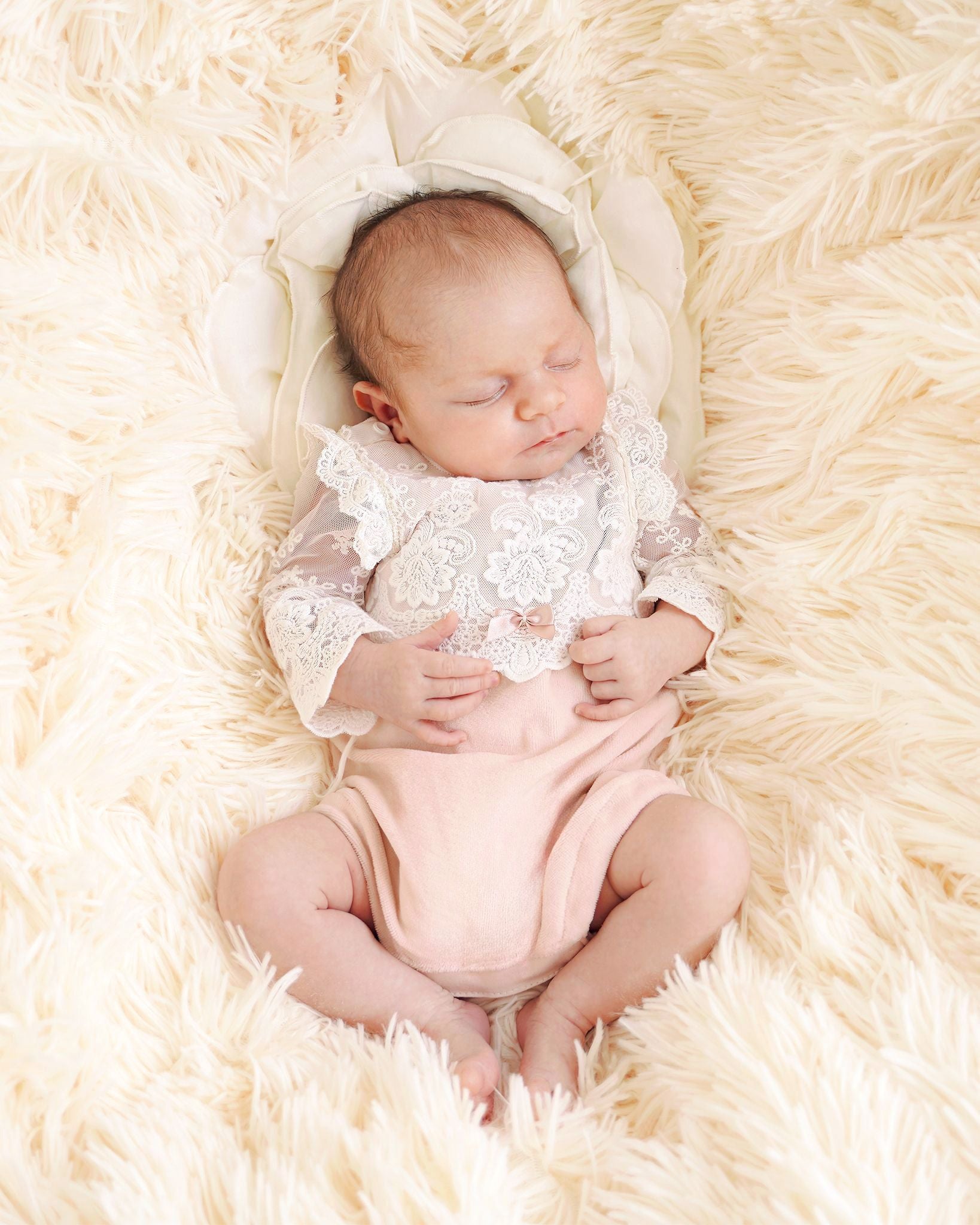 Baby trägt festlichen CUCOONU Body in Rosa aus Nickisamt mit Offwhite-Spitze, Vorderansicht